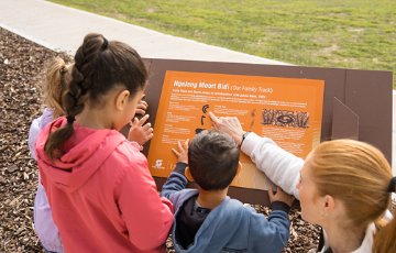 Children reading interpretative signage